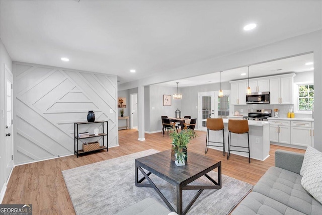 3951 Lindley Dr, Powder Springs, GA 30127 - living area featuring light wood finished floors, recessed lighting, a decorative wall, and baseboards