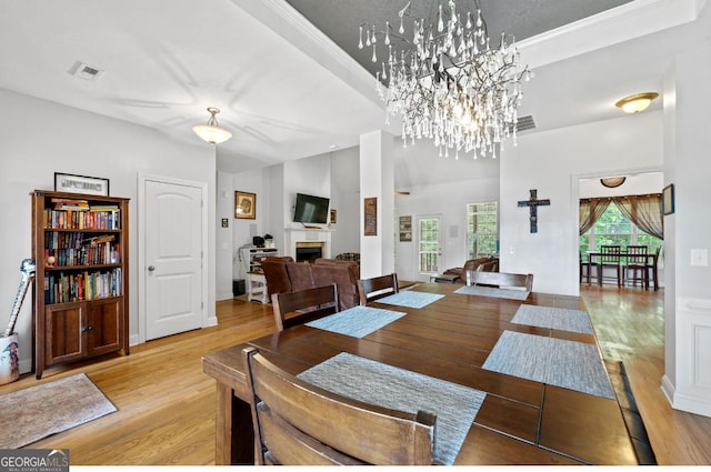 dining area with baseboards, wood finished floors, and a notable chandelier