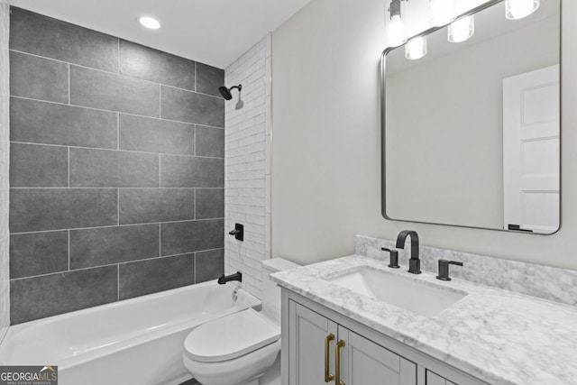 bathroom featuring vanity, toilet, and bathing tub / shower combination