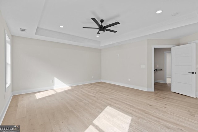 unfurnished room featuring recessed lighting, visible vents, a raised ceiling, and light wood-type flooring