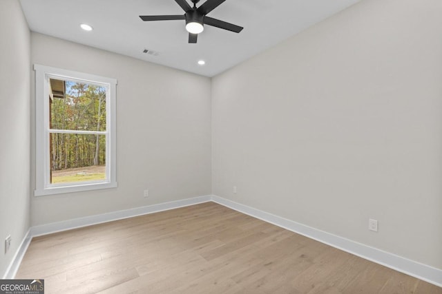 unfurnished room featuring a ceiling fan, baseboards, and light wood-style floors