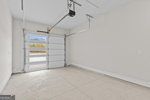 garage featuring a garage door opener and baseboards
