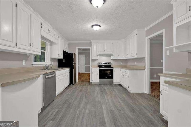 kitchen with white cabinets, stainless steel appliances, dark wood-style flooring, and light countertops
