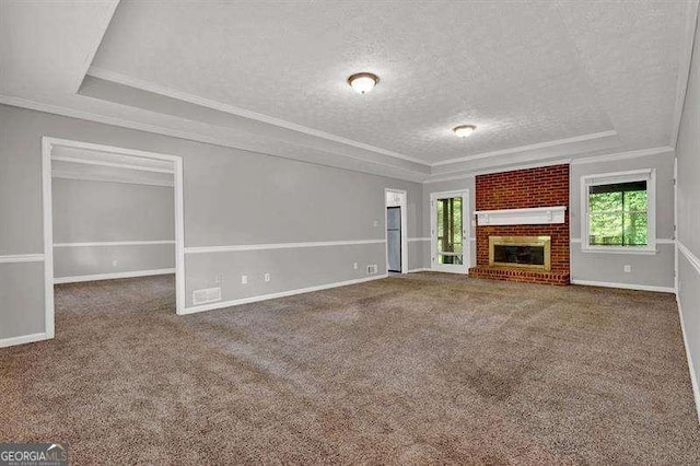 unfurnished living room featuring a textured ceiling, carpet flooring, and a tray ceiling