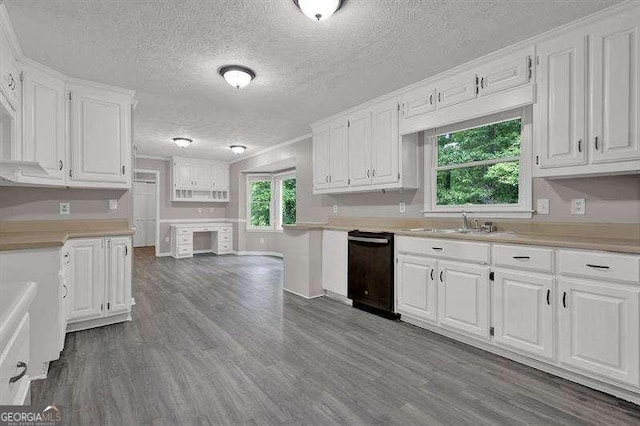 kitchen featuring black dishwasher, light countertops, and white cabinets