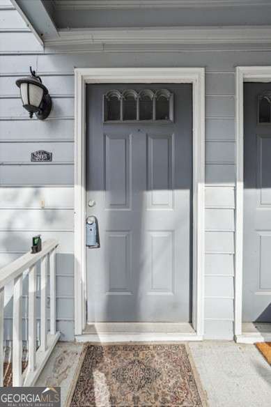 3980 Riverlook Pkwy SE Unit 203, Marietta, GA 30067 - view of front of property featuring roof with shingles and stairs