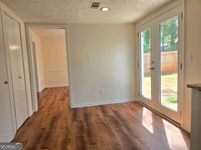 5229 Mountain Village Ct, Stone Mountain, GA 30083 - interior space with visible vents, baseboards, a textured ceiling, french doors, and wood finished floors