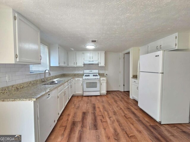 5229 Mountain Village Ct, Stone Mountain, GA 30083 - kitchen featuring wood finished floors, white appliances, under cabinet range hood, backsplash, and a sink