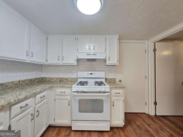 5229 Mountain Village Ct, Stone Mountain, GA 30083 - kitchen with dark wood-style floors, white cabinets, white gas range oven, and under cabinet range hood