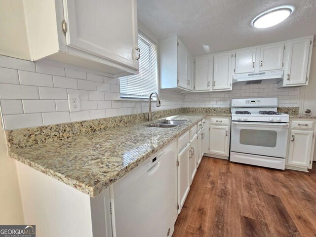 5229 Mountain Village Ct, Stone Mountain, GA 30083 - kitchen with white cabinetry, a sink, under cabinet range hood, dark wood-style flooring, and white appliances
