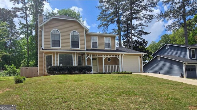 5229 Mountain Village Ct, Stone Mountain, GA 30083 - traditional home featuring a porch, a front yard, a garage, a chimney, and concrete driveway