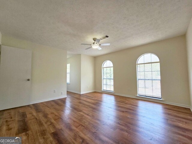 5229 Mountain Village Ct, Stone Mountain, GA 30083 - unfurnished room featuring ceiling fan, visible vents, baseboards, a textured ceiling, and wood finished floors