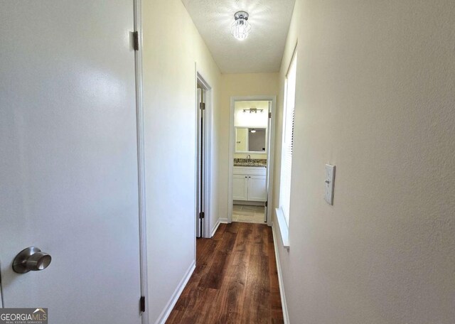 5229 Mountain Village Ct, Stone Mountain, GA 30083 - hall featuring a sink, dark wood finished floors, and baseboards