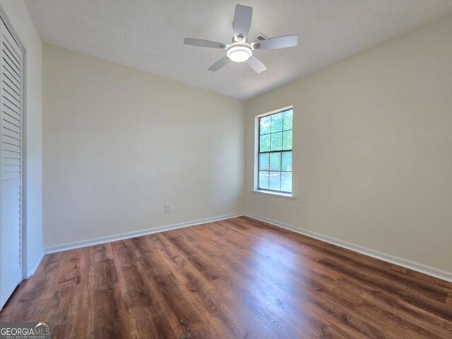 5229 Mountain Village Ct, Stone Mountain, GA 30083 - empty room featuring ceiling fan, wood finished floors, and baseboards