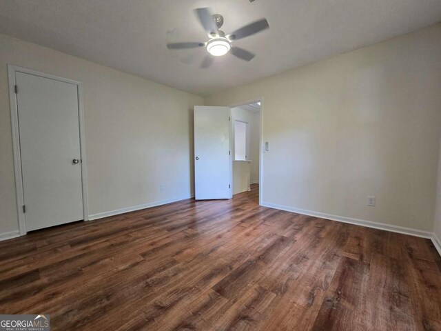 5229 Mountain Village Ct, Stone Mountain, GA 30083 - unfurnished bedroom featuring ceiling fan, baseboards, and dark wood finished floors
