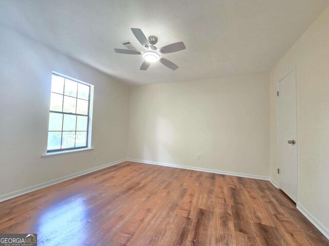 5229 Mountain Village Ct, Stone Mountain, GA 30083 - spare room featuring wood finished floors, ceiling fan, and baseboards