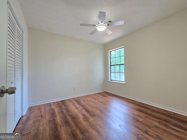 5229 Mountain Village Ct, Stone Mountain, GA 30083 - spare room featuring wood finished floors, ceiling fan, and baseboards