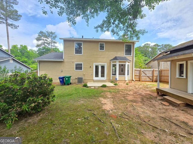 5229 Mountain Village Ct, Stone Mountain, GA 30083 - back of house featuring central AC, fence, french doors, and a lawn