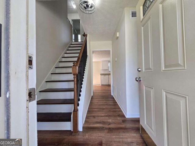 5229 Mountain Village Ct, Stone Mountain, GA 30083 - entryway with a textured ceiling, visible vents, baseboards, dark wood finished floors, and stairs