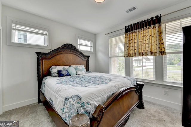 carpeted bedroom featuring baseboards and visible vents