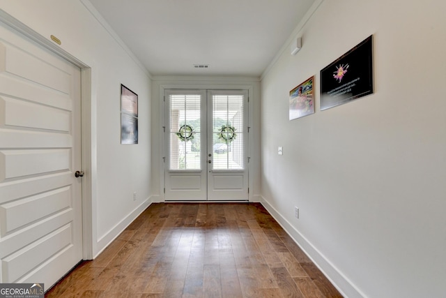 doorway to outside with visible vents, french doors, baseboards, ornamental molding, and wood finished floors