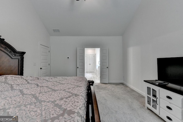 bedroom with light colored carpet, visible vents, and baseboards