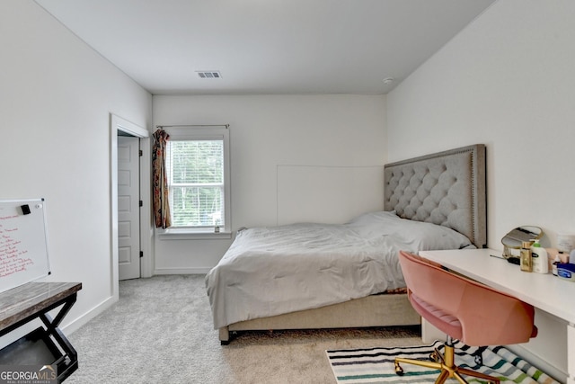 carpeted bedroom featuring baseboards and visible vents