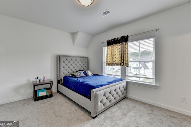 bedroom with baseboards, visible vents, and carpet