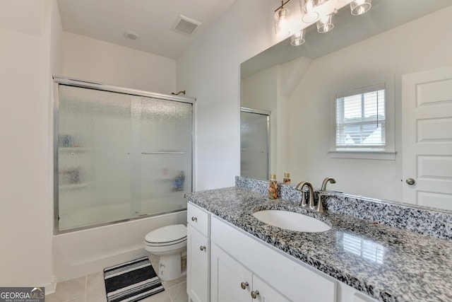 full bathroom with tile patterned floors, shower / bath combination with glass door, toilet, vanity, and visible vents