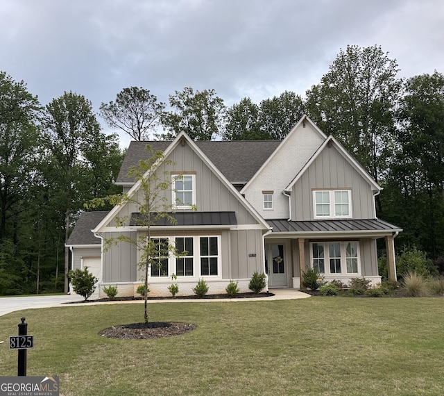 modern farmhouse style home featuring a standing seam roof, board and batten siding, a shingled roof, and a front yard