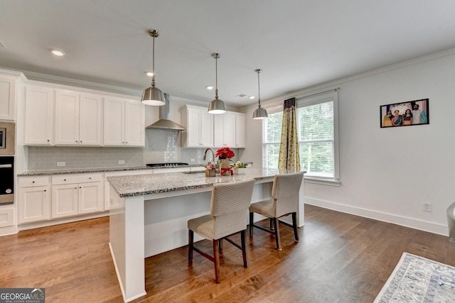 kitchen with stainless steel appliances, decorative backsplash, and white cabinets