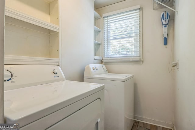 laundry area with separate washer and dryer, laundry area, and baseboards