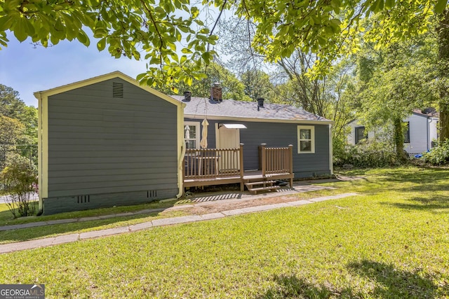 back of house with a chimney, a yard, crawl space, and a wooden deck