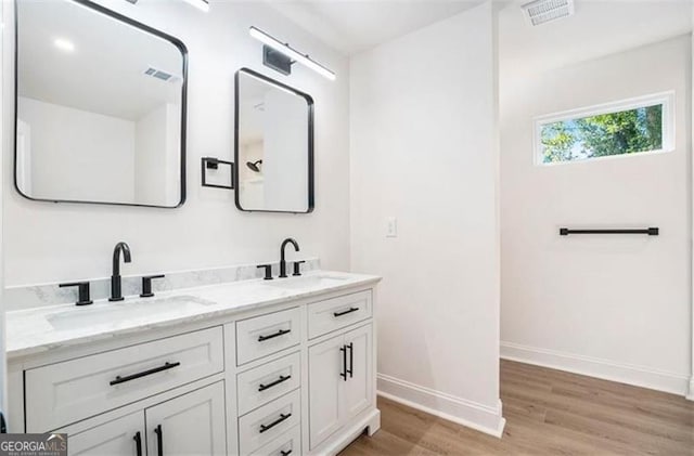3105 Jones, Atlanta, GA 30344 - full bathroom featuring double vanity, a sink, wood finished floors, and baseboards