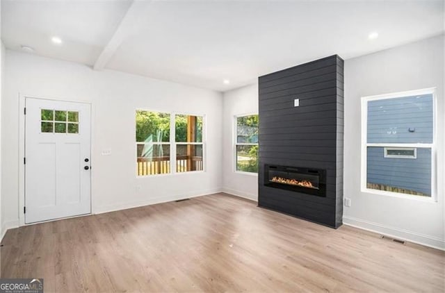 3105 Jones, Atlanta, GA 30344 - unfurnished living room featuring a fireplace, a wealth of natural light, and wood finished floors