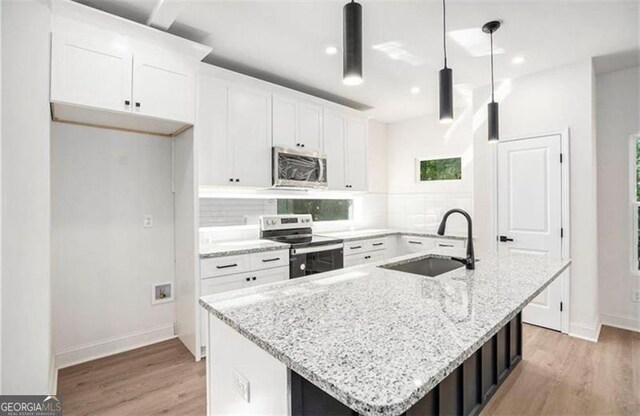 3105 Jones, Atlanta, GA 30344 - kitchen with white cabinets, a sink, appliances with stainless steel finishes, light wood-type flooring, and backsplash