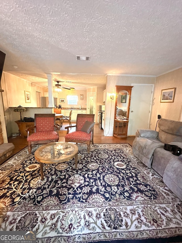 350 Kitty Hawk Ln, Clarkesville, GA 30523 - living area with wood finished floors, ceiling fan, a textured ceiling, and visible vents