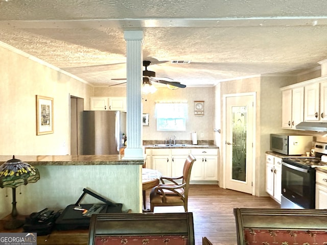 350 Kitty Hawk Ln, Clarkesville, GA 30523 - kitchen featuring crown molding, decorative columns, appliances with stainless steel finishes, and dark wood-style floors