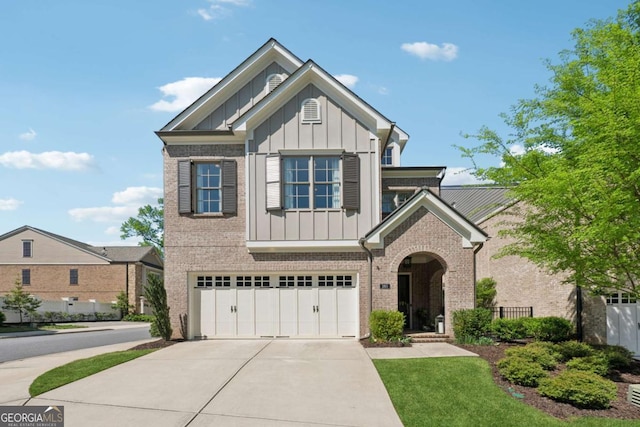 260 Jasmine Garden Way, Alpharetta, GA 30009 - craftsman house featuring board and batten siding, concrete driveway, an attached garage, fence, and brick siding