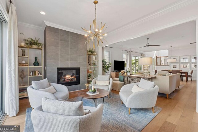260 Jasmine Garden Way, Alpharetta, GA 30009 - living room with ornamental molding, recessed lighting, a tiled fireplace, and light wood-style floors