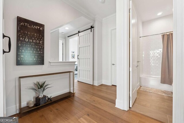 260 Jasmine Garden Way, Alpharetta, GA 30009 - hallway featuring recessed lighting, a barn door, baseboards, ornamental molding, and wood finished floors