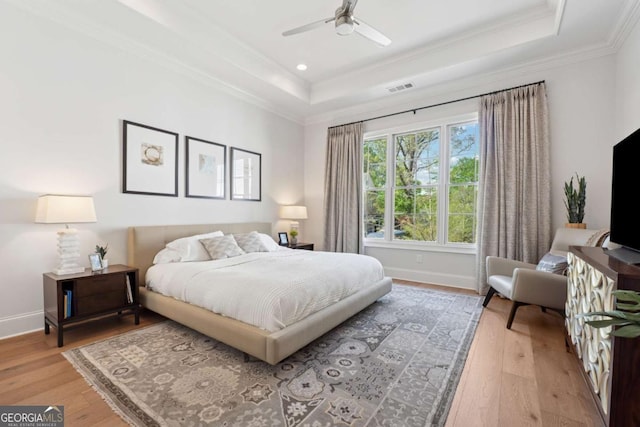 260 Jasmine Garden Way, Alpharetta, GA 30009 - bedroom featuring crown molding, visible vents, a tray ceiling, baseboards, and light wood-type flooring