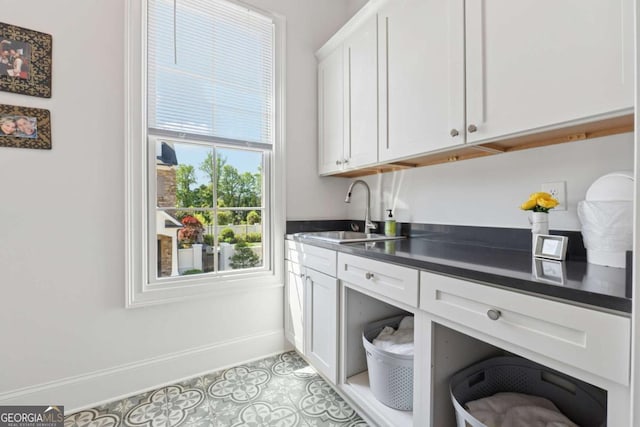 260 Jasmine Garden Way, Alpharetta, GA 30009 - laundry area featuring light tile patterned floors, baseboards, cabinet space, and a sink