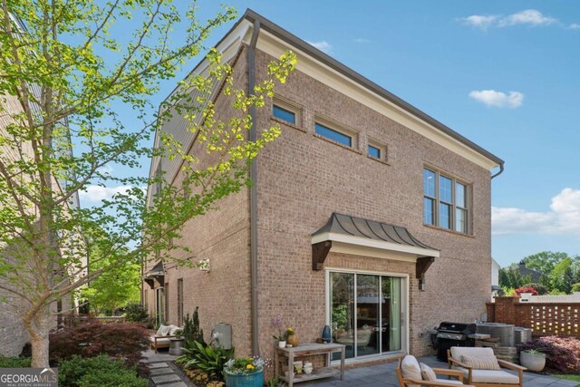 260 Jasmine Garden Way, Alpharetta, GA 30009 - back of house featuring a patio and brick siding