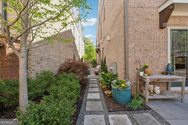 260 Jasmine Garden Way, Alpharetta, GA 30009 - view of home's exterior with a patio and brick siding