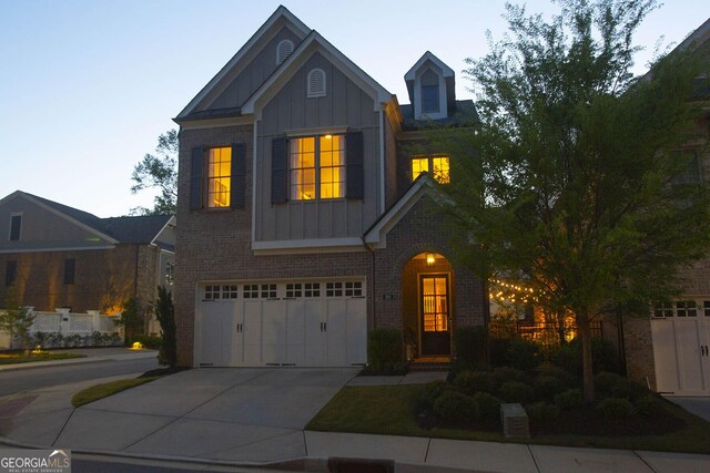 260 Jasmine Garden Way, Alpharetta, GA 30009 - view of front facade with concrete driveway, an attached garage, board and batten siding, and brick siding