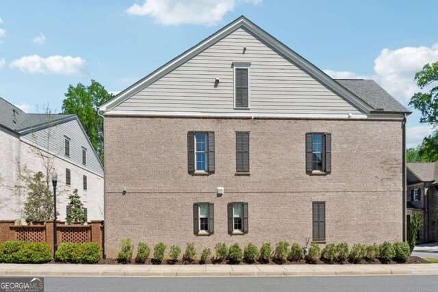 260 Jasmine Garden Way, Alpharetta, GA 30009 - view of property exterior featuring fence and brick siding