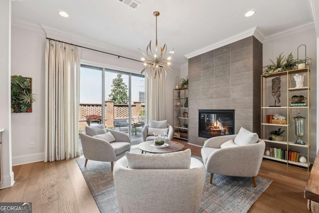 260 Jasmine Garden Way, Alpharetta, GA 30009 - living room featuring a tile fireplace, crown molding, and baseboards
