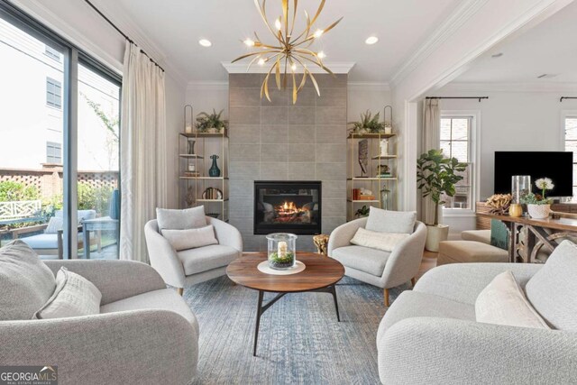 260 Jasmine Garden Way, Alpharetta, GA 30009 - living room featuring a fireplace, a chandelier, crown molding, and recessed lighting