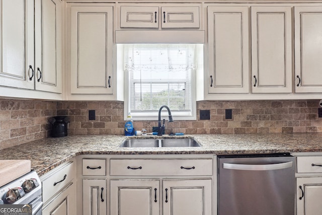 kitchen featuring stainless steel dishwasher, stove, decorative backsplash, and a sink